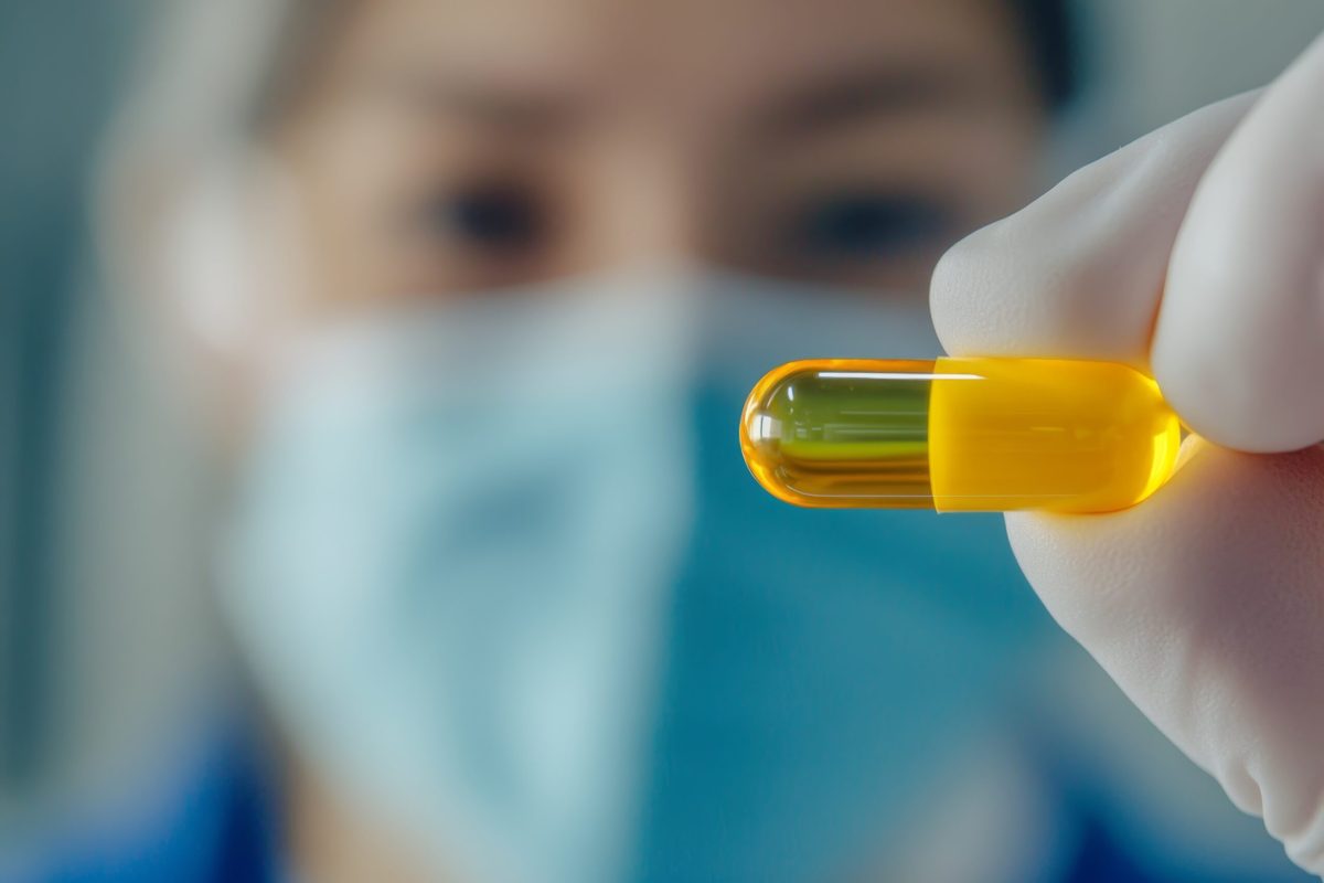 Vecteezy healthcare professional holds a yellow capsule while 57307204 scaled.jpeg