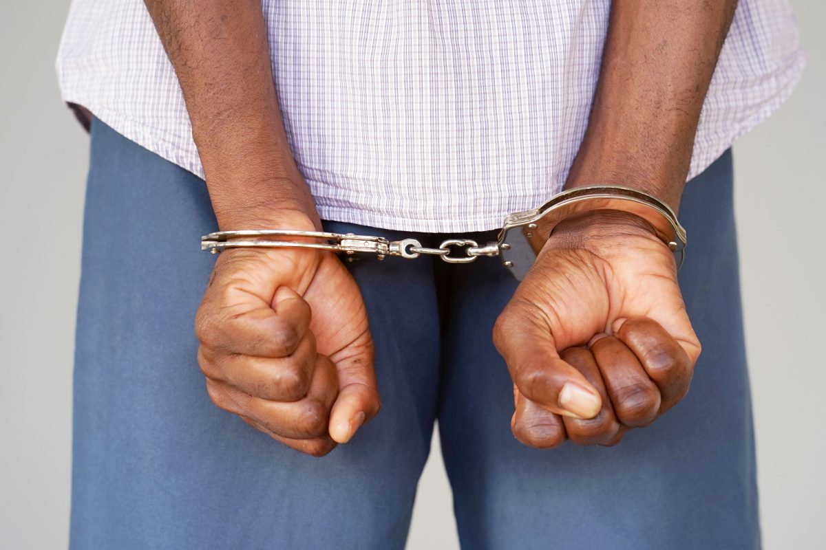 Vecteezy black hands locked in handcuffs close up view 6934437728129 2 1 scaled.jpg