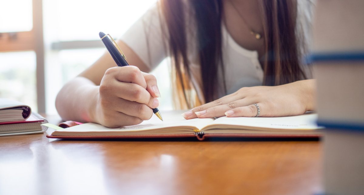 Vecteezy female students writing and reading in the library 20172134 scaled.jpg
