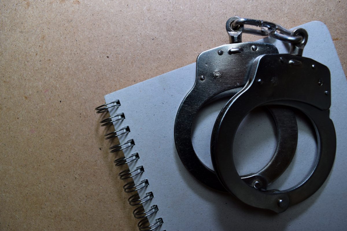 Vecteezy handcuffs steel isolated on wooden background 23641265 1 scaled.jpg