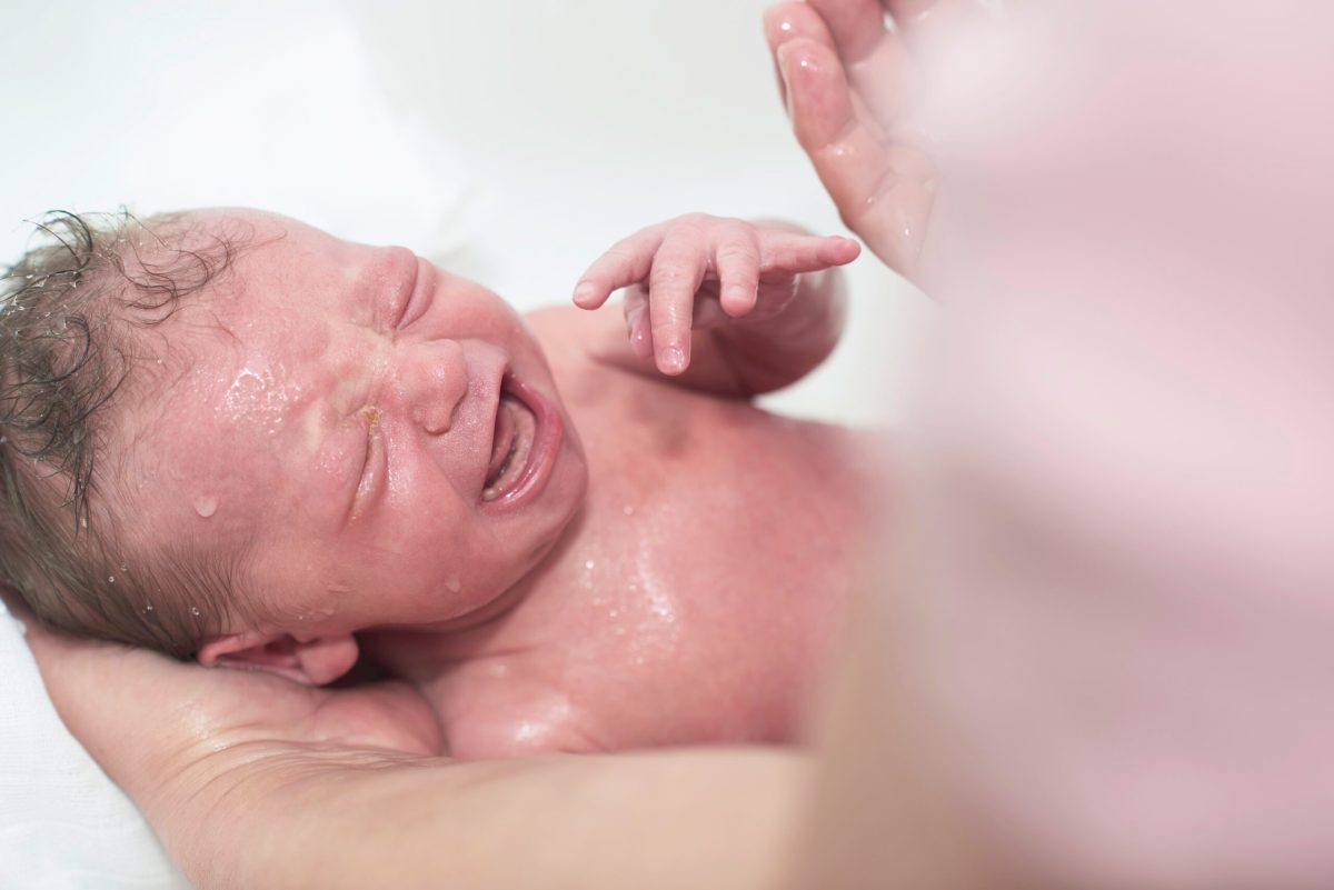 Vecteezy newborn baby girl taking a first bath 31023398 scaled.jpg